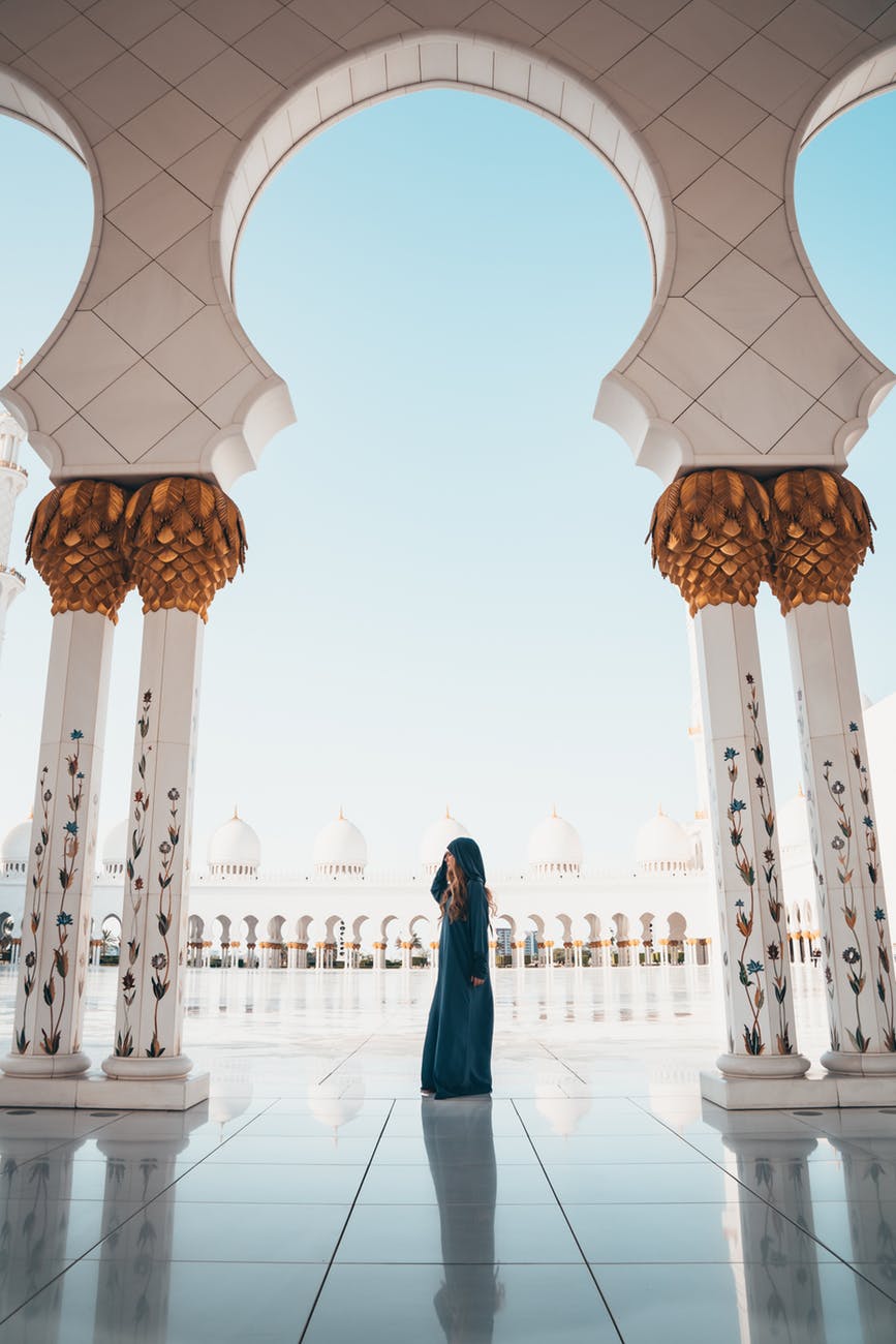 photo of woman wearing blue coat