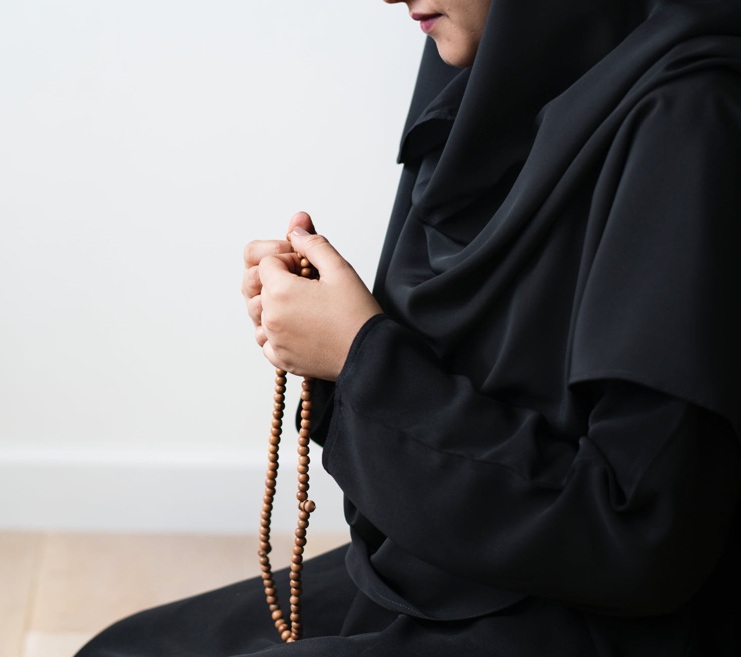 woman holding prayer beads
