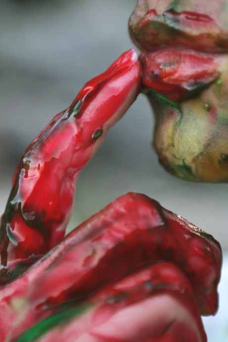 person hand full of red liquid