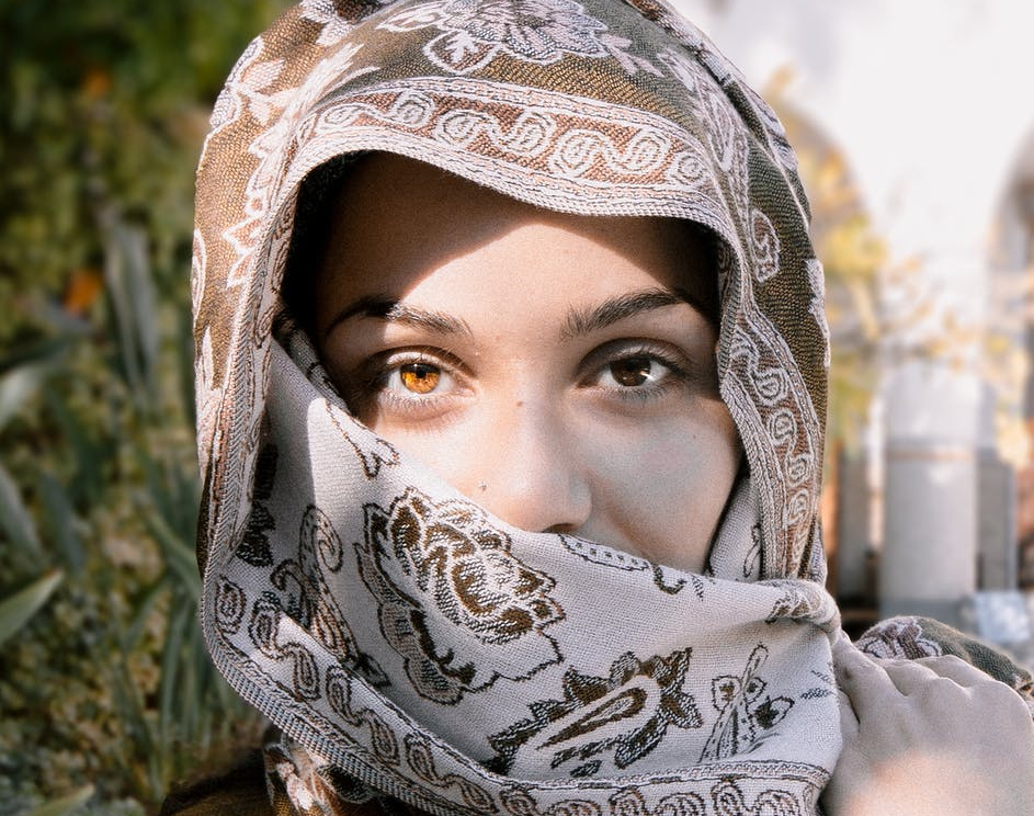 close up photo of a woman wearing brown and beige headscarf